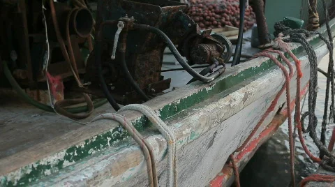 Rusty boat equipment on deck and used ropes hanging over the edge HD Stock Footage 826992