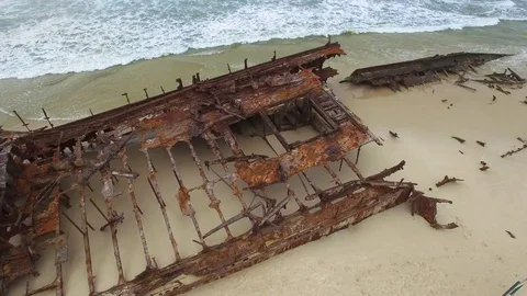Rusty boat on shore with waves Stock Footage 79703027