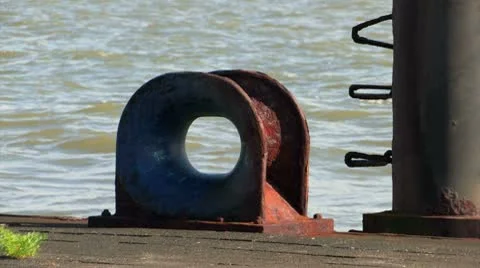 Rusty bolder in the harbor Stock Footage 8836608