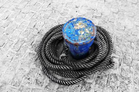 Rusty bollard with ropes Stock Photos