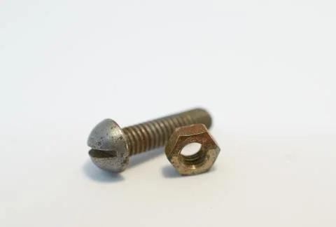 Rusty bolt and nut lie next each other on gray background Stock Photos
