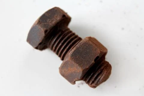 Rusty bolt and nut made of chocolate isolated on white background Stock Photos