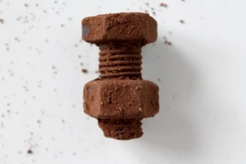 Rusty bolt and nut made of chocolate isolated on white background Stock Photos