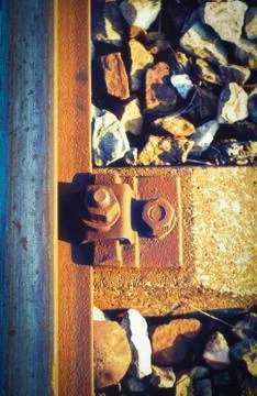Rusty bolt and screw nut next to a rail steel beam Stock Photos
