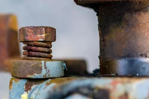 Rusty bolt and spring, macro side view. Stock Photos