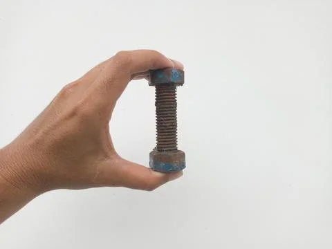 Rusty bolt held in human hand Stock Photos