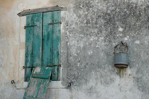 Rusty bucket on moldy wall Stock Photos