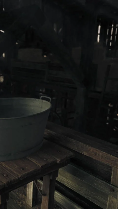 Rusty bucket placed on wooden table in empty barn during daytime Stock Footage 341235482