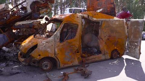 A rusty burnt van after shelling van parked next to scrap metal Stock Footage 264325004