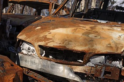 Rusty car that burned at a scrapyard Stock Photos