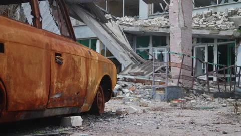 Rusty car damaged and burnt left at public place in Kherson after russian defeat Video stock 231978974