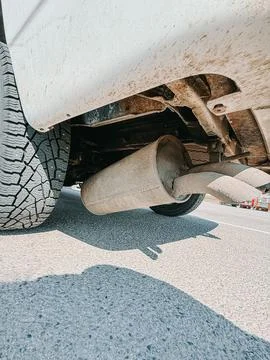 Rusty Car Exhaust Muffler Underside Close-Up on Road Photos
