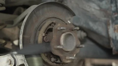 A rusty car wheel hub assembly exposed during brake repair. Stock Footage 342263380
