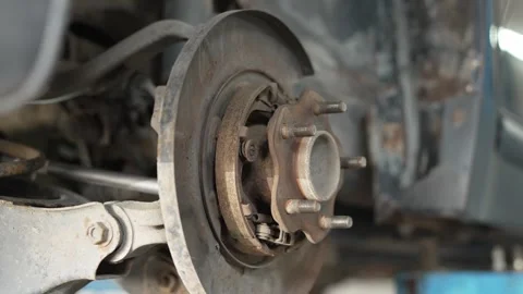 A rusty car wheel hub assembly exposed during brake repair. Stock Footage 342263611