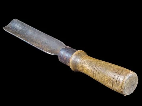 Rusty carpenter chisel with wooden handle isolated on black Stock Photos