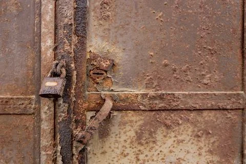 Rusty castle on a rusty iron gate 스톡 사진