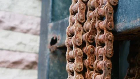 Rusty chain with corrosion on a dirty surface, detail texture Stock Photos