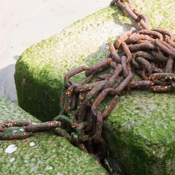 Rusty chain on the harbour Stock Photos
