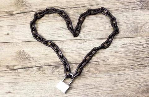 Rusty chain heart shape on the lock. Stock Photos