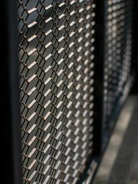 Rusty Chain Link Fence Mesh in Diagonal Perspective with Sunlight Stock Photos