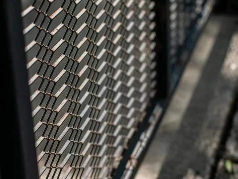 Rusty Chain Link Fence Mesh in Diagonal Perspective with Sunlight Stock Photos