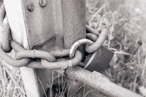 Rusty chain locked with a padlock Stock Photos