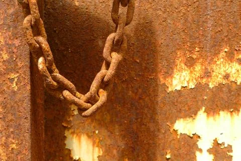 Rusty chain over rusty background Stock Photos