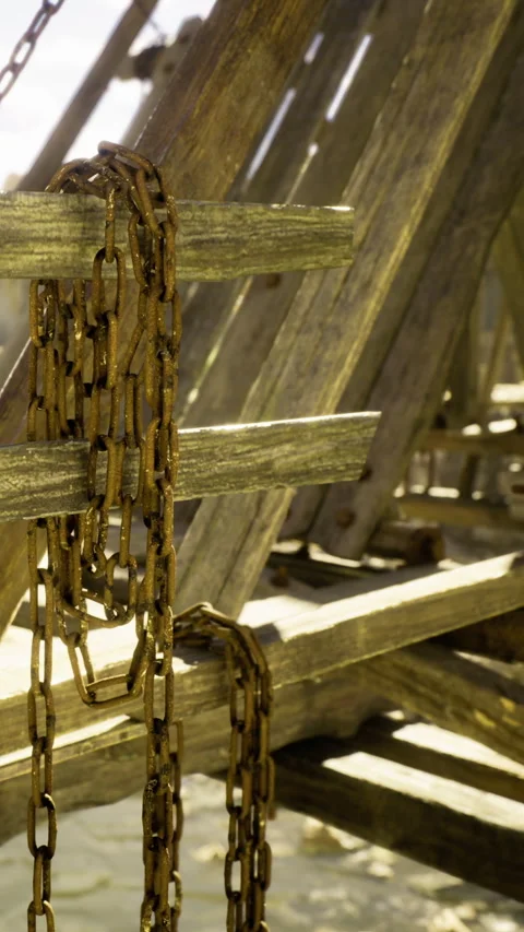 Rusty chains dangle from weathered wooden beams at the seaside dock Stock Footage 331803541