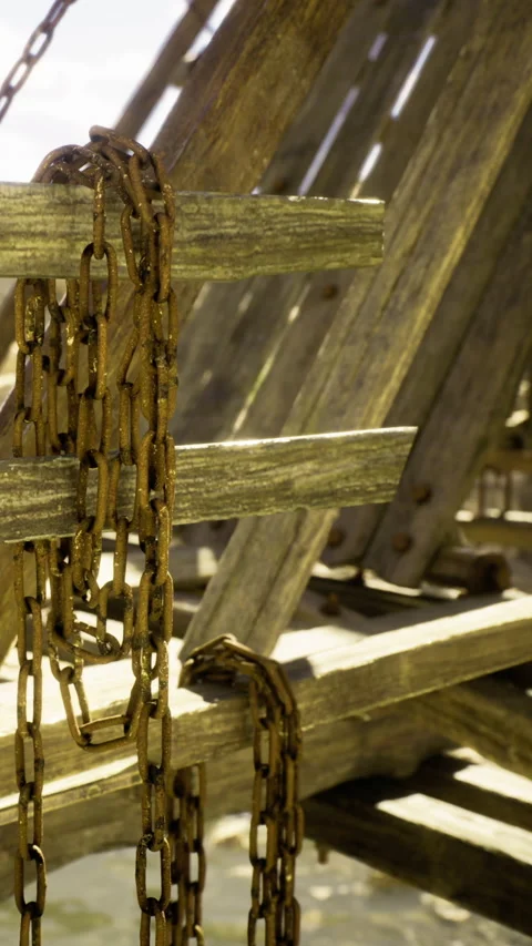 Rusty chains draped over weathered wooden structure at tranquil beach Stock Footage 331803539