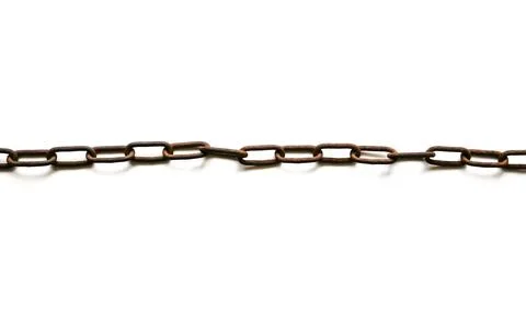 Rusty chains lying on the table. Stock Photos