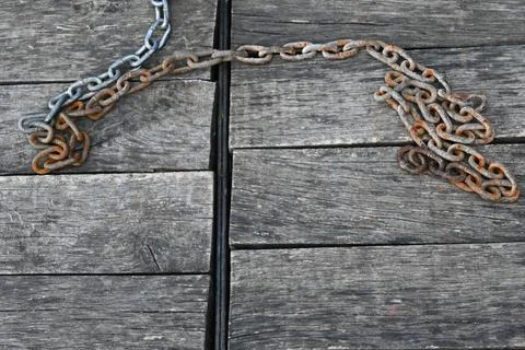 Rusty chains on weathered wood Stock Photos