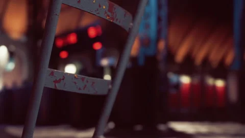 Rusty chair in empty space with faint lights in the background Stock-Footage 343574880