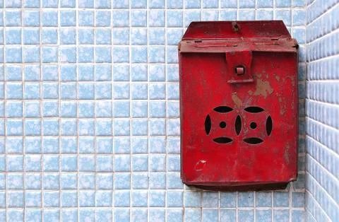Rusty Chinese postbox on a blue tiled wall, Hong Kong Stock Photos