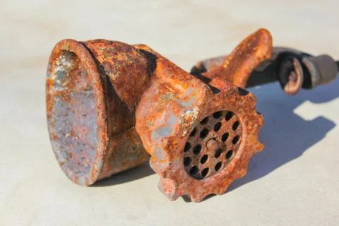 Rusty chopper lies on a light background. Russian manual machine for minced m Stock Photos