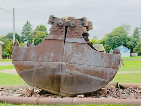A rusty clamshell mining shovel Stock Photos