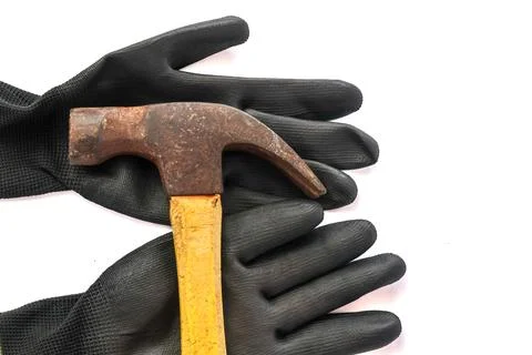 Rusty claw hammer on black work gloves background. Photos