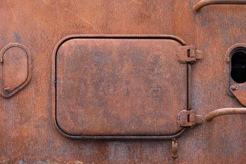 Rusty closed hatch on the surface  of a destroyed airborne amphibious Stock Photos