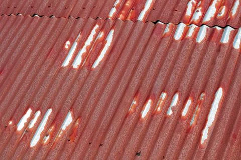 Rusty Corrugated Metal Surface Texture Showing Wear and Tear, Creating Weathe Stock Photos