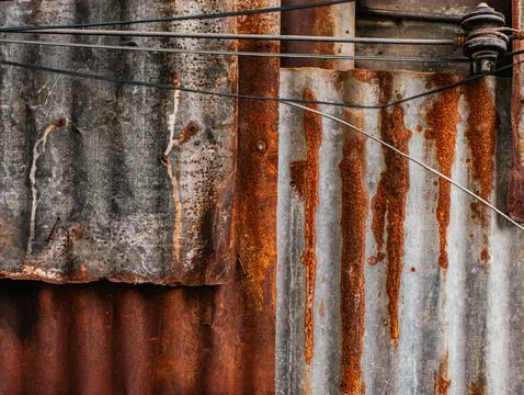 Rusty Corrugated Metal Wall with Tangled Electric Wires and Ceramic Insulator Stock Photos