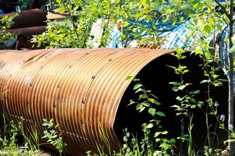 A rusty culvert laying in a scape metal yard Stock Photos