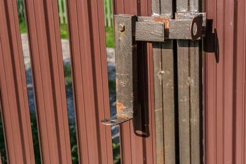 Rusty deadbolt for entry gate. Stock Photos