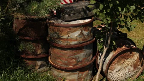 Rusty destroyed fuel barrels on outside, military elements after artillery fire Stock-Footage 188035843