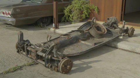 Rusty discarded automobile chassis on concrete Stock-Footage 335732322
