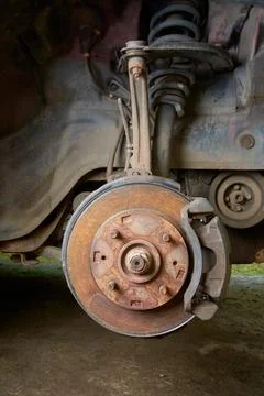 Rusty disk brake, steering knuckle and suspension Stock Photos
