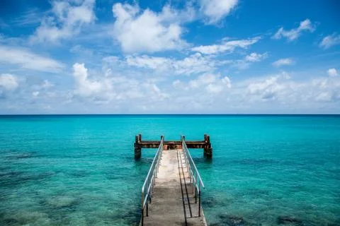 Rusty dock at Bermuda beach Stock Photos