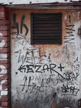 Rusty door with bars. Painted with graffiti Stock Photos