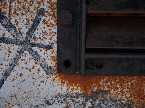 Rusty door with bars. Painted with graffiti Stock Photos