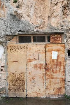 Rusty door in rock Stock Photos