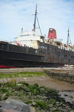 Rusty Duke Of Lancaster Ship Docked In North Wales With Muddy Shoreline Stock Photos