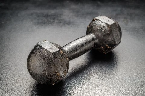 A Rusty dumbbell on black  background Foto stock